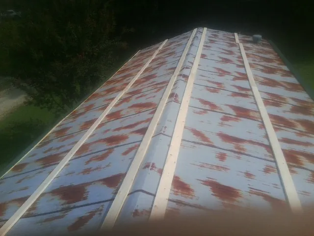 Rusted metal roof panels with new wood purlins before replacement — Storm Damage Roof Repair in Cragsmoor by Roofing Brothers